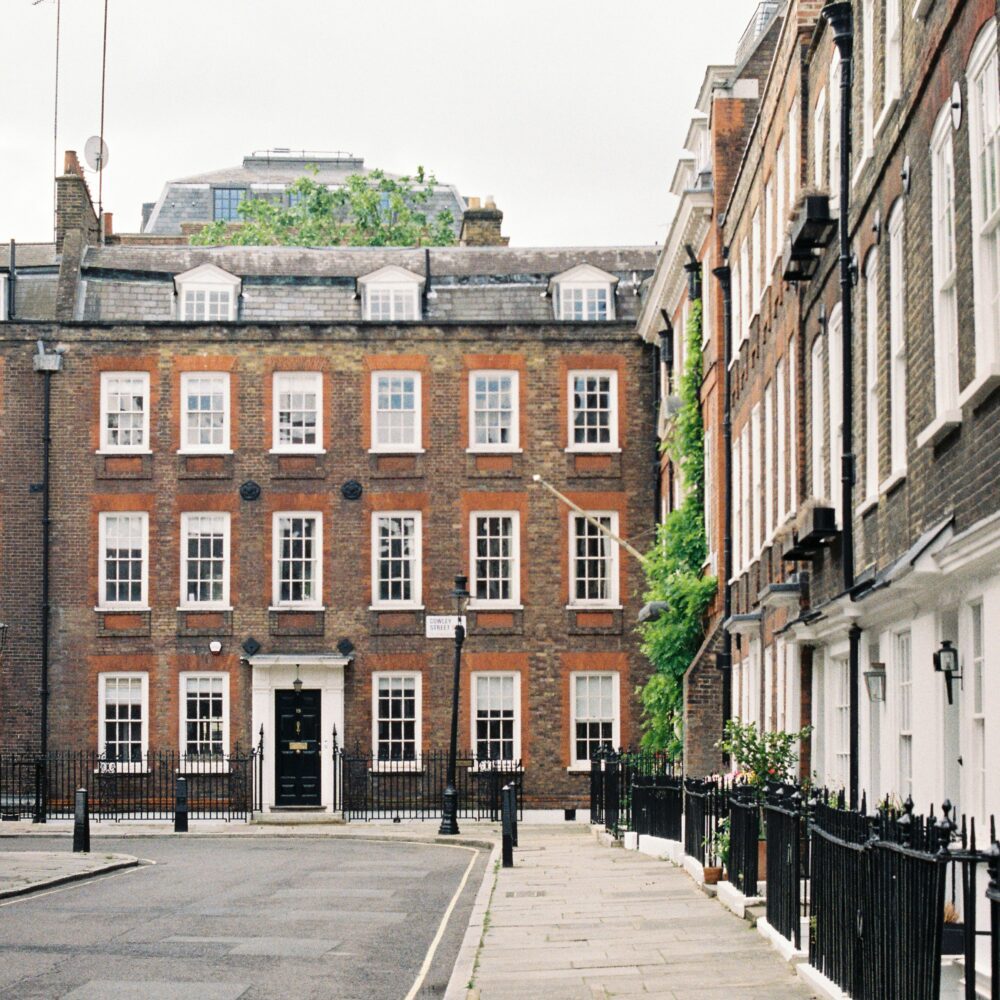 A row of brick flats in a city.